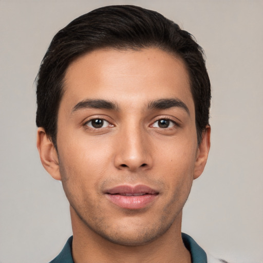 Joyful white young-adult male with short  black hair and brown eyes