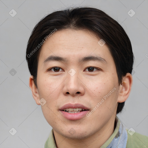 Joyful asian young-adult male with short  brown hair and brown eyes