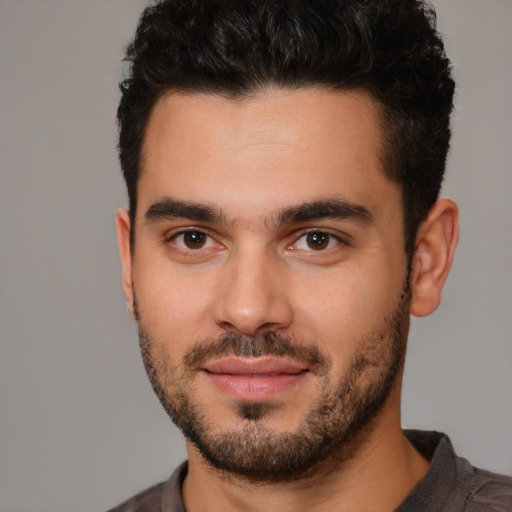 Joyful white young-adult male with short  black hair and brown eyes