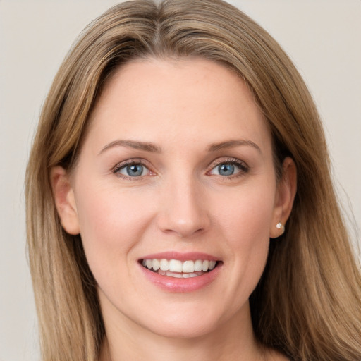 Joyful white young-adult female with long  brown hair and grey eyes