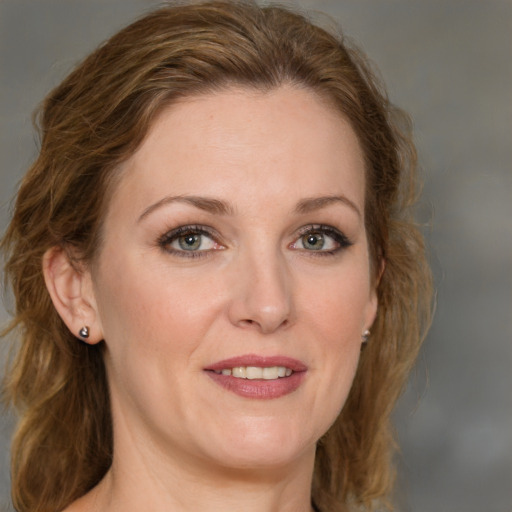 Joyful white young-adult female with medium  brown hair and green eyes