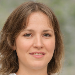 Joyful white young-adult female with medium  brown hair and green eyes