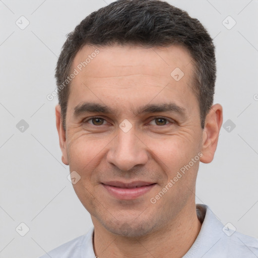 Joyful white adult male with short  brown hair and brown eyes