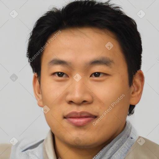 Joyful asian young-adult male with short  brown hair and brown eyes