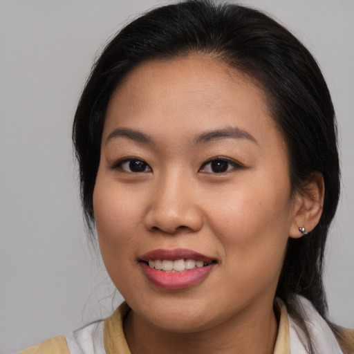 Joyful asian young-adult female with medium  brown hair and brown eyes