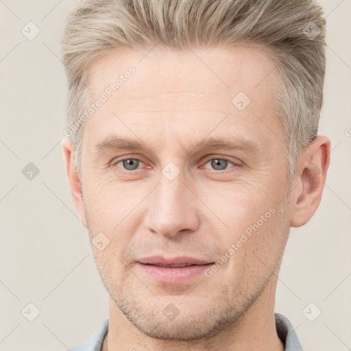 Joyful white adult male with short  brown hair and grey eyes