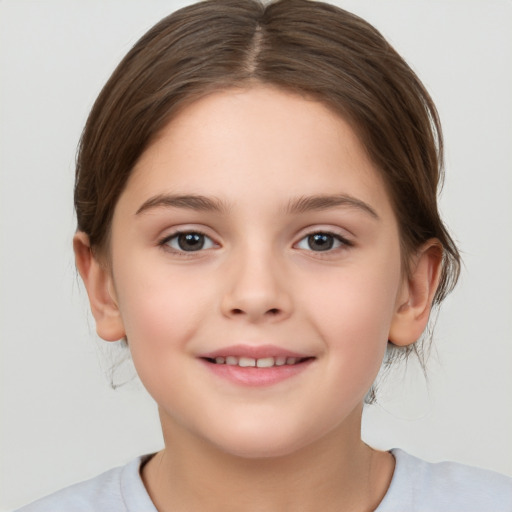 Joyful white child female with medium  brown hair and brown eyes