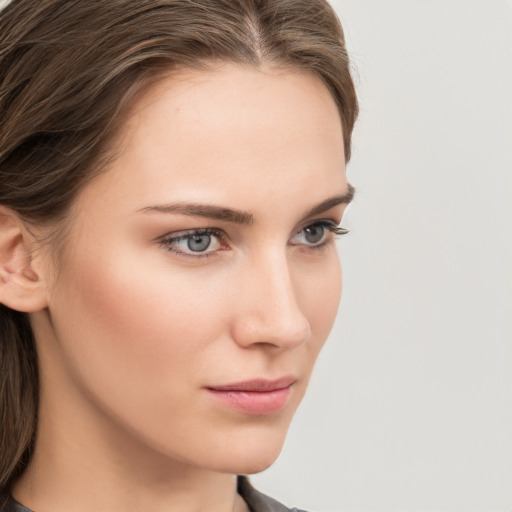 Neutral white young-adult female with long  brown hair and grey eyes