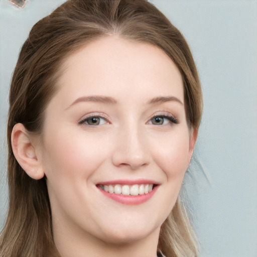 Joyful white young-adult female with long  brown hair and blue eyes