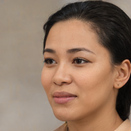 Joyful latino young-adult female with medium  brown hair and brown eyes