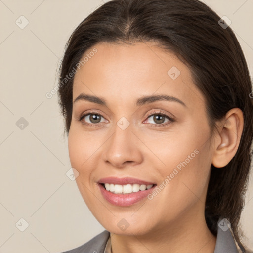 Joyful white young-adult female with medium  brown hair and brown eyes