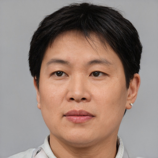 Joyful asian adult female with short  brown hair and brown eyes