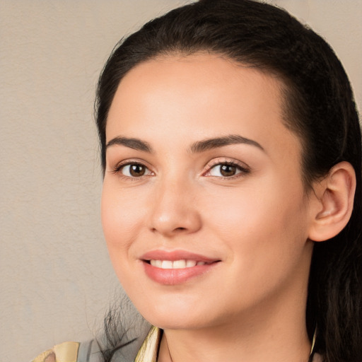 Joyful white young-adult female with long  black hair and brown eyes