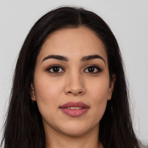 Joyful latino young-adult female with long  brown hair and brown eyes