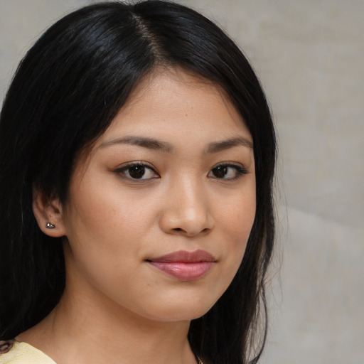 Joyful asian young-adult female with medium  brown hair and brown eyes