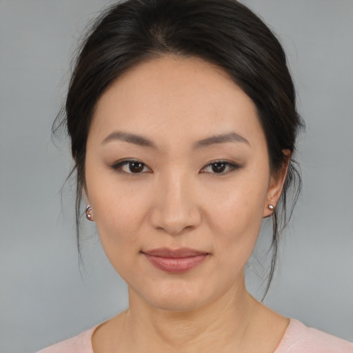 Joyful asian young-adult female with medium  brown hair and brown eyes