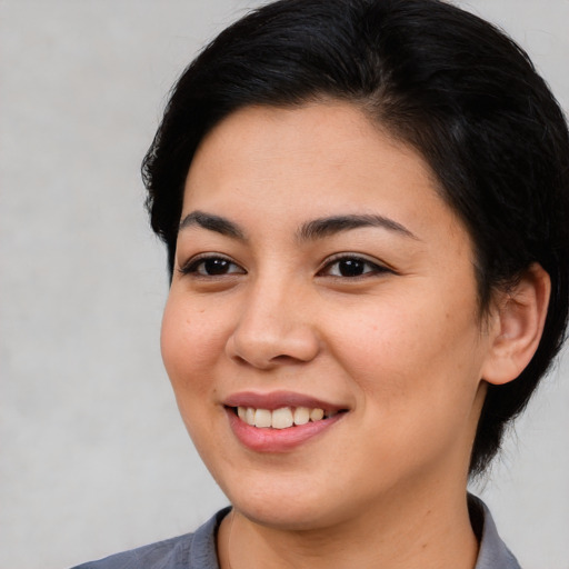 Joyful asian young-adult female with medium  brown hair and brown eyes