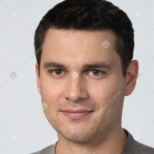 Joyful white young-adult male with short  brown hair and brown eyes