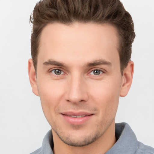 Joyful white young-adult male with short  brown hair and brown eyes