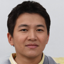 Joyful asian young-adult male with short  brown hair and brown eyes