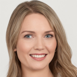 Joyful white young-adult female with long  brown hair and green eyes