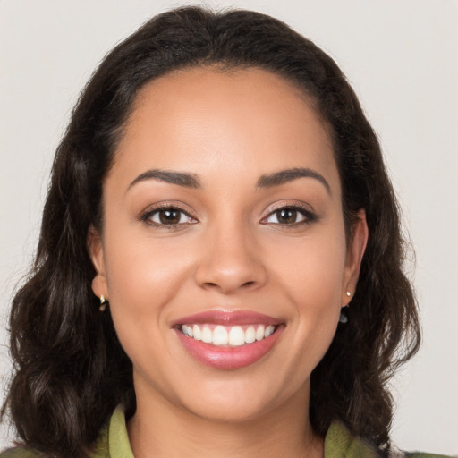 Joyful latino young-adult female with long  brown hair and brown eyes