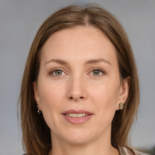 Joyful white adult female with medium  brown hair and grey eyes