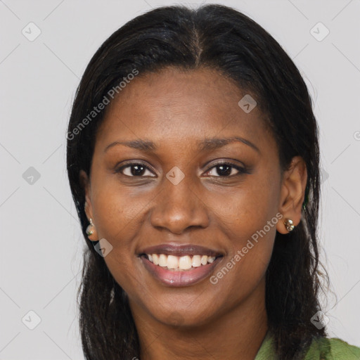 Joyful black young-adult female with long  brown hair and brown eyes