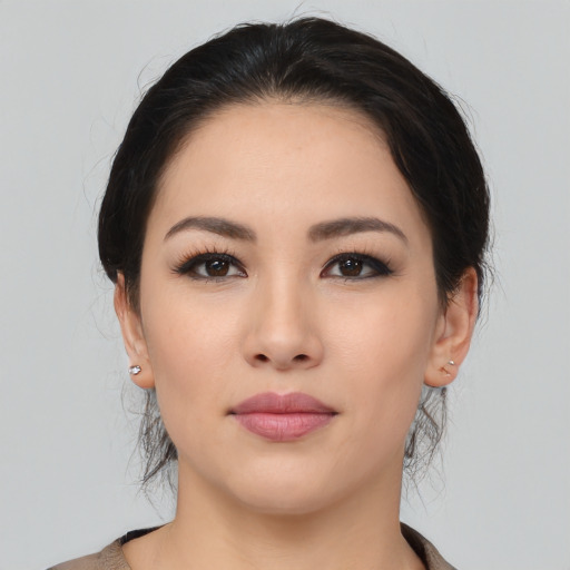 Joyful asian young-adult female with medium  black hair and brown eyes