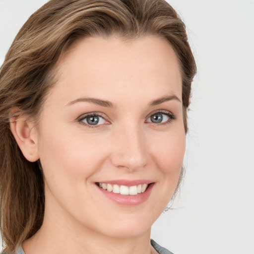 Joyful white young-adult female with long  brown hair and blue eyes