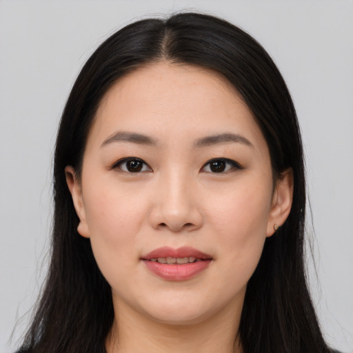 Joyful asian young-adult female with long  black hair and brown eyes