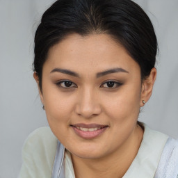 Joyful asian young-adult female with medium  brown hair and brown eyes