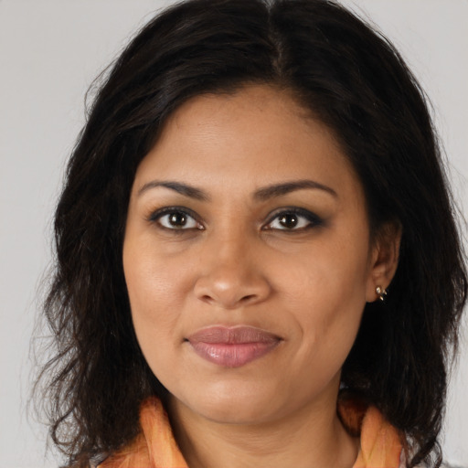 Joyful black young-adult female with long  brown hair and brown eyes