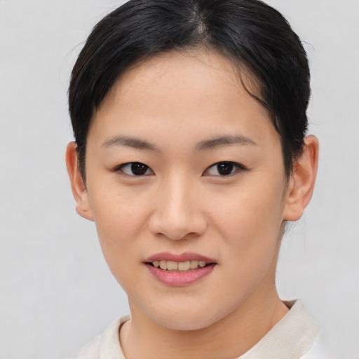 Joyful asian young-adult female with short  brown hair and brown eyes