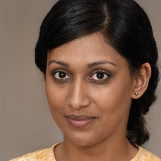 Joyful black young-adult female with medium  brown hair and brown eyes