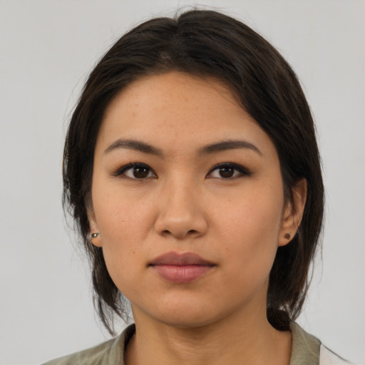 Neutral asian young-adult female with medium  brown hair and brown eyes