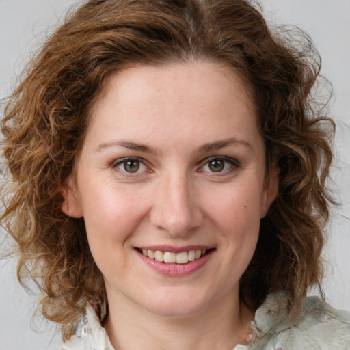 Joyful white young-adult female with medium  brown hair and green eyes