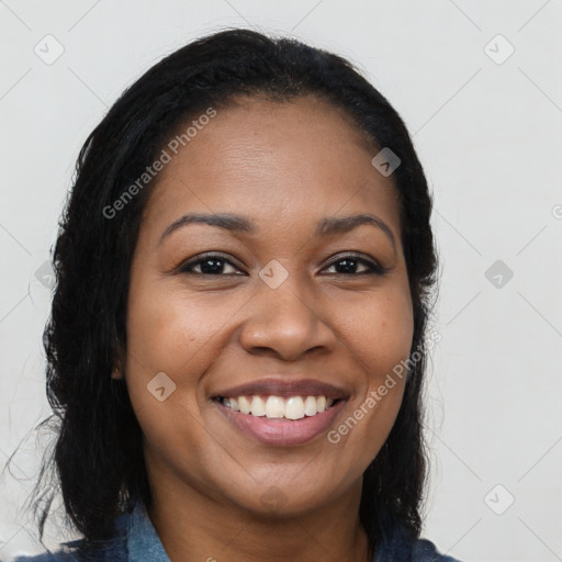 Joyful black young-adult female with long  black hair and brown eyes