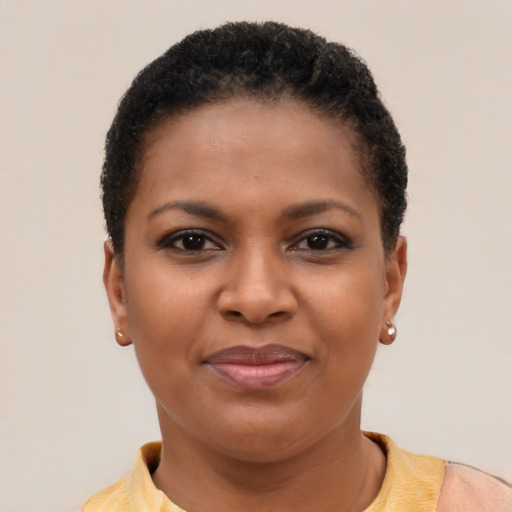 Joyful black young-adult female with short  brown hair and brown eyes