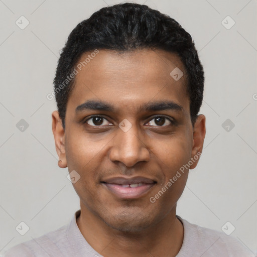 Joyful black young-adult male with short  black hair and brown eyes