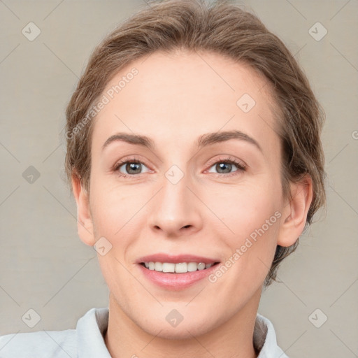 Joyful white adult female with medium  brown hair and grey eyes