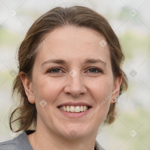 Joyful white adult female with medium  brown hair and grey eyes