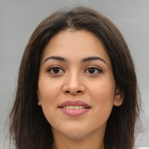 Joyful white young-adult female with long  brown hair and brown eyes