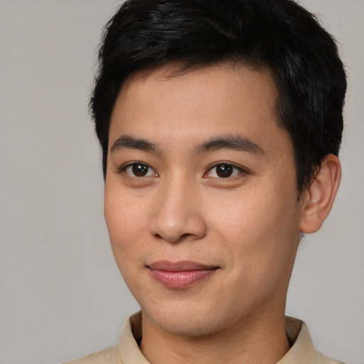 Joyful asian young-adult male with short  brown hair and brown eyes