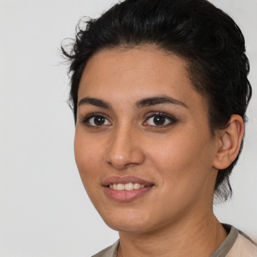 Joyful latino young-adult female with short  brown hair and brown eyes