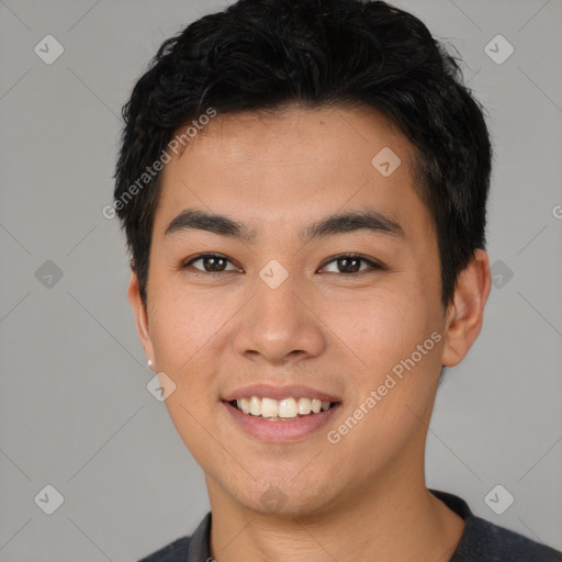 Joyful asian young-adult male with short  black hair and brown eyes