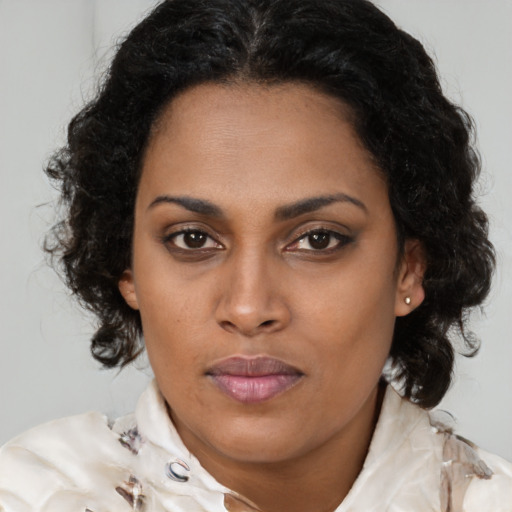 Joyful black young-adult female with medium  brown hair and brown eyes