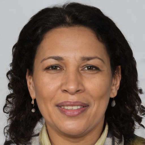 Joyful latino adult female with medium  brown hair and brown eyes