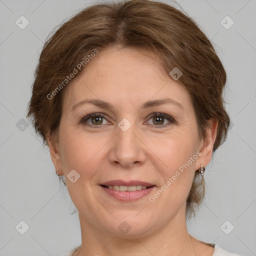 Joyful white adult female with medium  brown hair and grey eyes