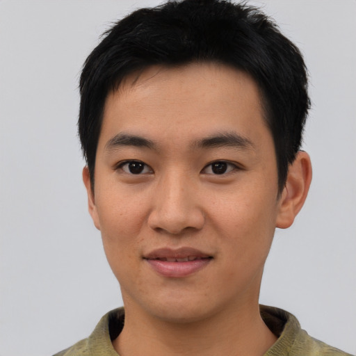 Joyful asian young-adult male with short  black hair and brown eyes